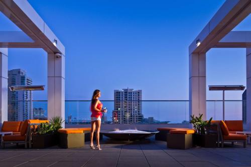 a woman standing on the roof of a building at Andaz San Diego, By Hyatt in San Diego