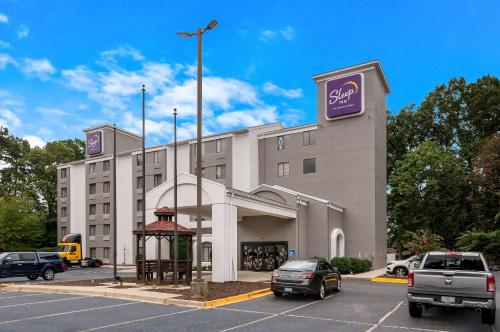 a hotel building with a gazebo in a parking lot at Sleep Inn Northlake in Charlotte
