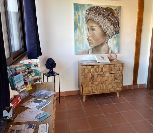a room with a painting of a woman on the wall at Don Vittorio Country Village in Taormina