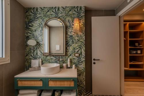 a bathroom with a sink and a mirror at Terradamari Resort & Spa Marina di Modica,Tapestry by Hilton in Marina di Modica