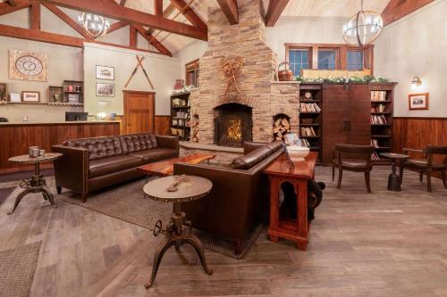 a living room with a couch and a fireplace at Corduroy Inn and Lodge, Trademark Collection by Wyndham in Snowshoe