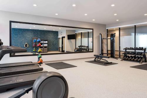 a gym with several treadmills and a mirror at La Quinta Inn and Suites by Wyndham Lincoln in Lincoln