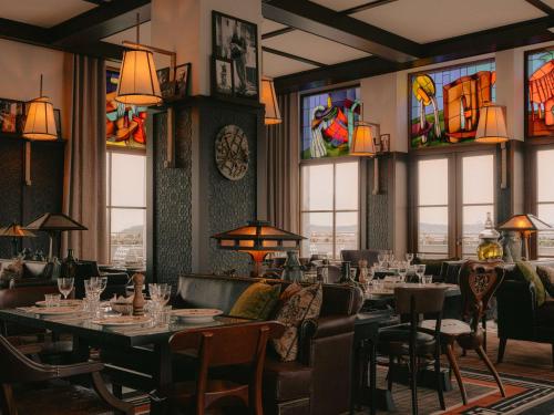 a restaurant with tables and chairs and stained glass windows at Maison Heler Metz, Curio Collection By Hilton in Metz