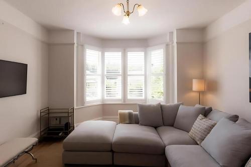 a living room with a white couch and a window at 'Sobrina=' - A home away from home in Sandy Bay in Sandy Bay