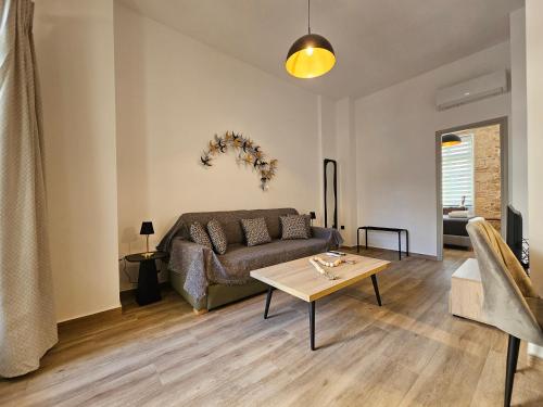 a living room with a couch and a table at Silk Suites by YHA in Athens