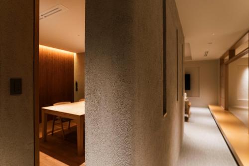 a hallway of a house with a table and a dining room at Shinzan Kinosaki in Toyooka