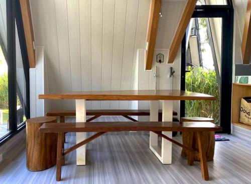 a wooden table and benches in a room at My Cabin by One Selah in Bustos