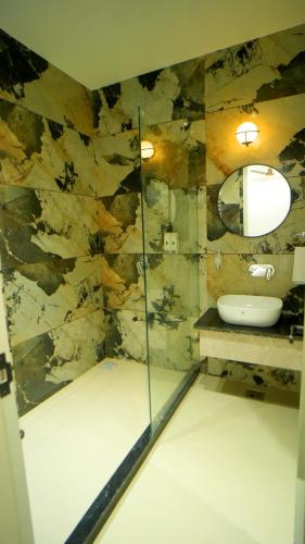 a bathroom with a sink and a mirror at HOTEL Elegance 5 min walk from Golden Temple in Amritsar