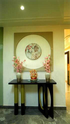 a table in a room with a plate on the wall at HOTEL Elegance 5 min walk from Golden Temple in Amritsar