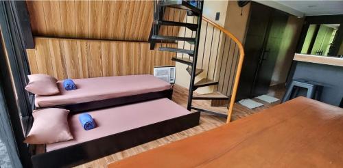 a living room with stairs and a stair case at My Cabin by One Selah in Bustos