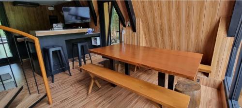 a wooden table and bench in a tiny house at My Cabin by One Selah in Bustos