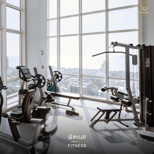 a gym with cardio equipment in a large room with windows at 2 Bed Room Seaview Luxury Room in Jomtien Beach