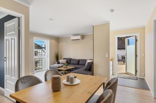 a dining room and living room with a table and chairs at ROOF HOUSE, Downtown in Sandefjord in Sandefjord