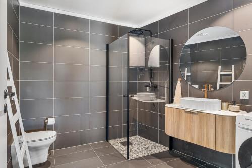 a bathroom with a toilet and a sink and a mirror at ROOF HOUSE, Downtown in Sandefjord in Sandefjord