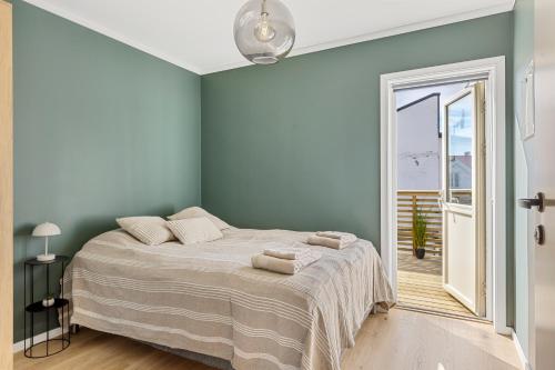 a bedroom with a bed in a room with a window at ROOF HOUSE, Downtown in Sandefjord in Sandefjord