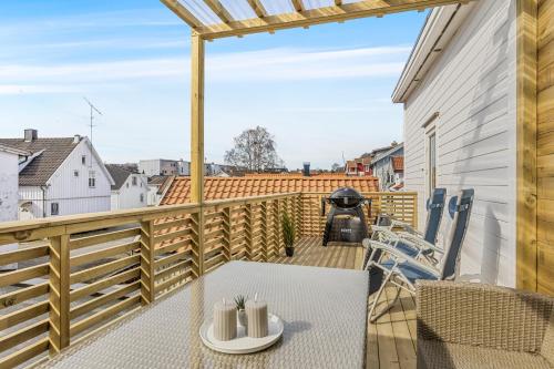 a patio with a table and chairs on a balcony at ROOF HOUSE, Downtown in Sandefjord in Sandefjord
