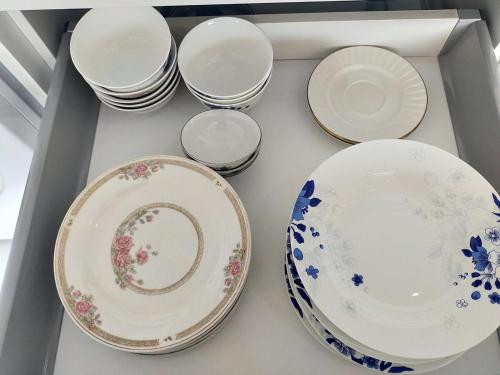 a group of plates and bowls in a drawer at 2 Bed Room Seaview Luxury Room in Jomtien Beach