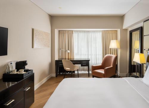 a hotel room with a bed and a desk at Radisson Blu Hotel Bucharest in Bucharest