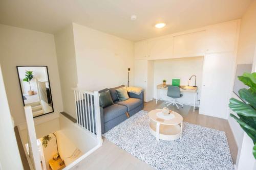 a living room with a couch and a table at Smart 50m2 One Bedroom Apartment - VW140C in Eindhoven