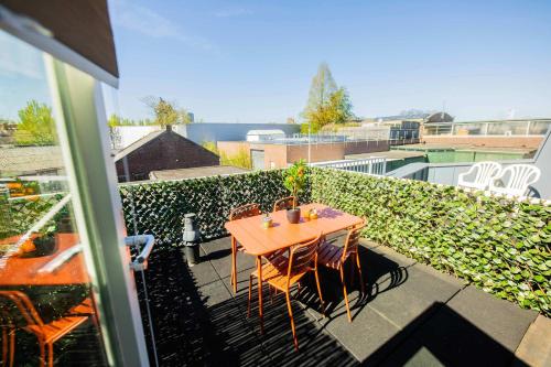 a table and chairs on top of a balcony at Smart 50m2 One Bedroom Apartment - VW140C in Eindhoven