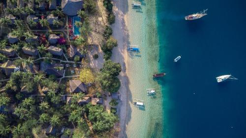 an aerial view of a beach with houses and boats at Vayam Boutique Resort Gili Asahan in Gili Asahan