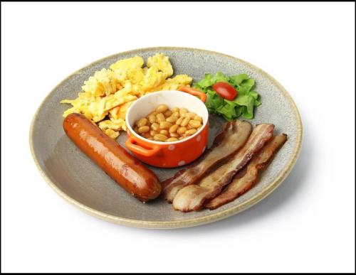 a plate of food with sausage beans and scrambled eggs at Le Saint Germain in Hua Hin