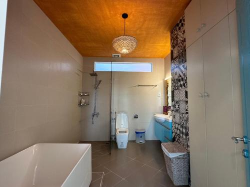 a bathroom with a tub and a toilet and a sink at Notre Maison 7 - COliving and COworking in Ho Chi Minh City