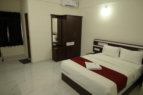 a bedroom with a large bed in a room at CAT'S EYE Hotel in Cochin