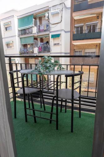 a table and two chairs on a balcony at Acogedor Apartamento Valencia 3 dormitorios in Aldaia
