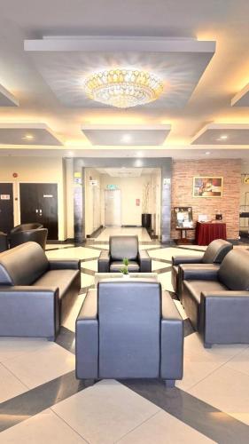 a large lobby with couches and a chandelier at Hotel Seri Malaysia Kepala Batas in Kepala Batas