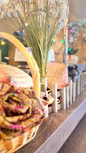 a basket sitting on a counter with a vase at Hotel Seri Malaysia Kepala Batas in Kepala Batas