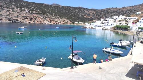 a group of boats in a large body of water at Faros Sea View Studio - Sifnos in Faros