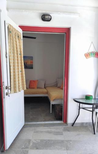a door leading into a living room with a couch at Faros Sea View Studio - Sifnos in Faros