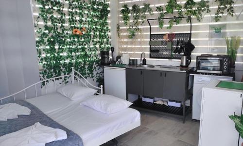 a bedroom with two beds and a desk and a sink at Faros Sea View Studio - Sifnos in Faros