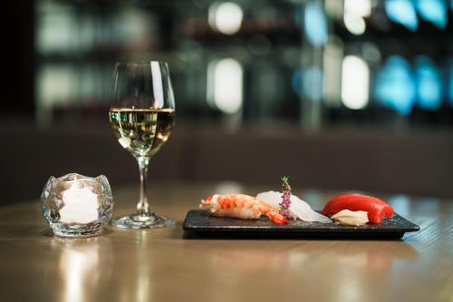 a glass of wine next to a plate of food at The Hotel Seiryu Kyoto Kiyomizu - a member of the Leading Hotels of the World- in Kyoto