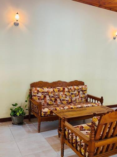 a room with two wooden benches and a table at Udawalawa Eco Lodge in Udawalawe