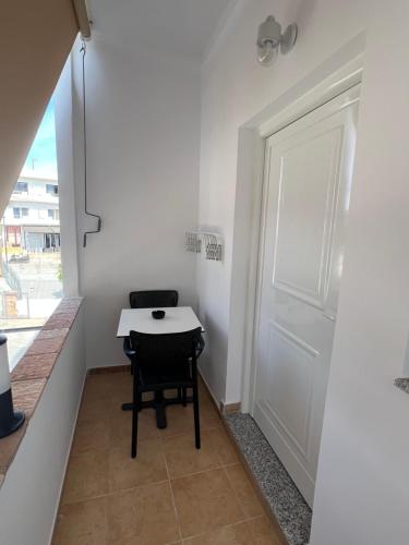 a small room with a table and a door at House Pollo in Ksamil