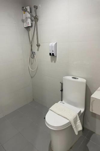 a white bathroom with a toilet and a shower at TJ 4711 Residence in Maha Sarakham