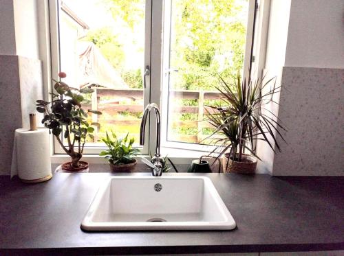 a kitchen counter with a sink and a window at Saltwater Apartment Gdynia in Gdynia