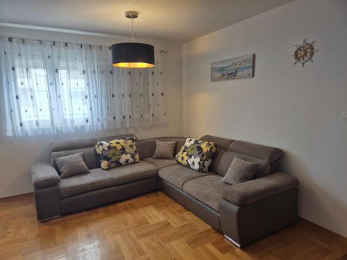 a living room with a couch in a room at Apartment ŽNJAN in Split
