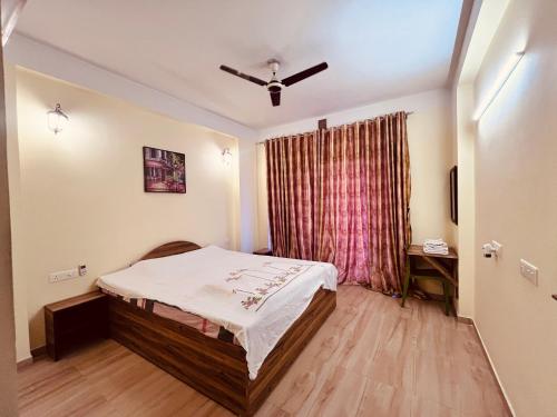 a small bedroom with a bed and a window at Paradise Villa in Siliguri