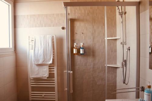 a shower with a glass door in a bathroom at Villa Susca - villa sul mare in Monopoli
