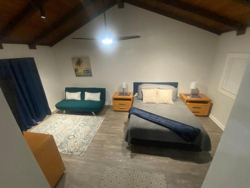 a bedroom with a bed and a blue chair at BonVoyage-Sleep&Sail Overnight Stays-Sleeps 6-8 in Long Beach