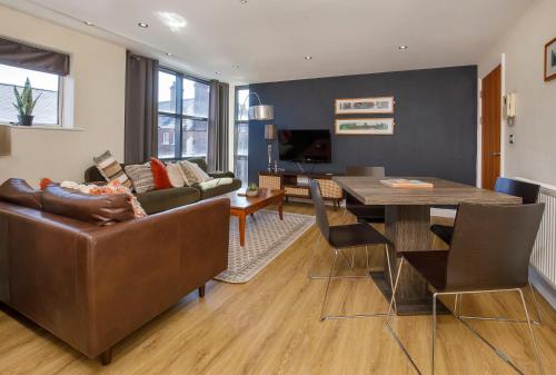 a living room with a couch and a table at Aspire Apartments York in York