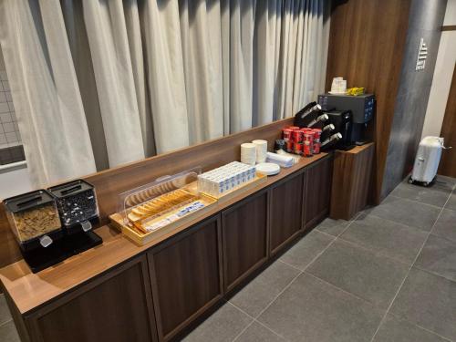 a reception desk in a hotel room with food at Aank Hotel and Spa Jongno Unni in Seoul