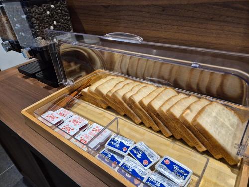 a plastic container of bread in a machine at Aank Hotel and Spa Jongno Unni in Seoul