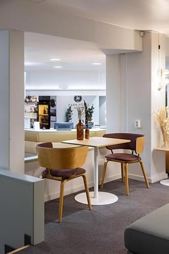 a living room with a table and two chairs at Finlandia Park Hotel Helsinki in Helsinki