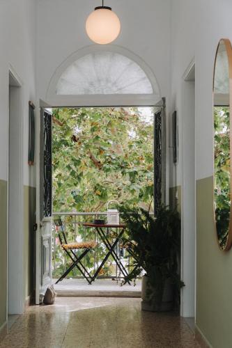 an open door to a patio with a table outside at Leoni's House near the Beach in Kremasti