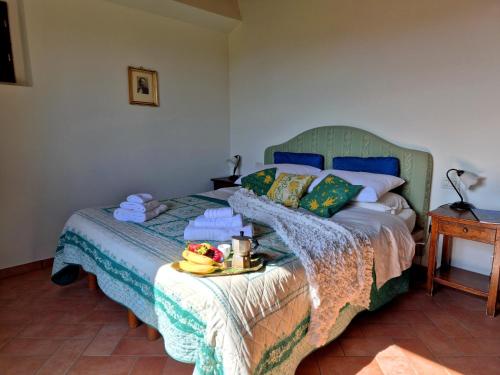 a bedroom with a bed with a tray of fruit on it at Agriturismo il Pino - Bioagricoltura in Monticello