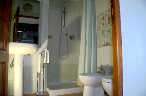 a bathroom with a shower and a sink and a toilet at Agriturismo il Pino - Bioagricoltura in Monticello